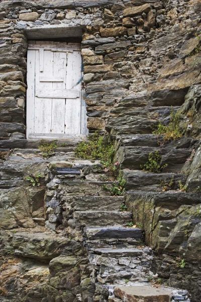 Italy, Vernazza Rock steps lead to an old door